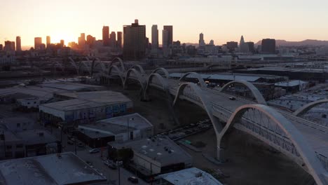 Low-close-up-aerial-shot-of-the-Sixth-Street-Bridge-and-Viaduct-at-sunset-in-Los-Angeles,-California