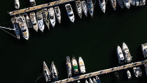 Private-yachts-moored-in-local-pier-of-Estepona,-aerial-top-down-view