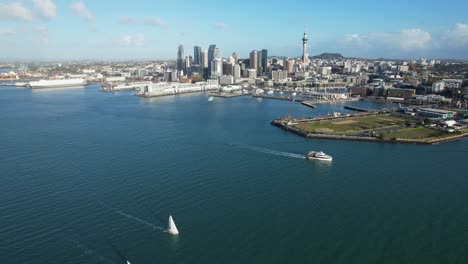 Sailboats-And-Ferry-Terminal-Cruising-At-Waitemata-Harbour-With-A-View-Of-Auckland-CBD-In-Daytime-In-New-Zealand