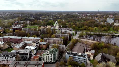 Aerial-drone-fly-above-Riga-Latvia-autumnal-landscape-city-buildings-green-Park