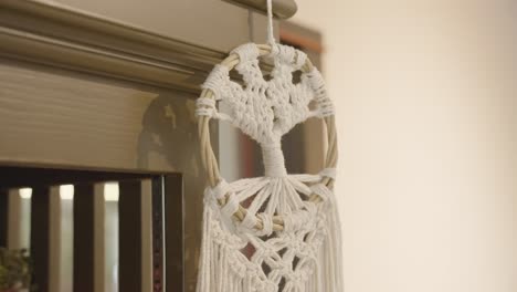 Handcrafted-wall-decor-designed-in-the-art-of-macrame-weaving-using-natural-beige-threads