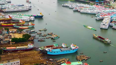 Aerial-of-busy-shipping-port-on-the-Buriganga-River,-Bangladesh-with-colourful-boats