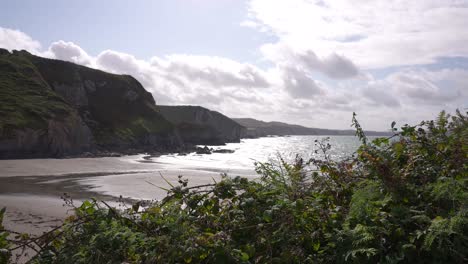 Beach-and-Bay-on-Dinas-Island,-Wales-UK,-Picturesque-Coastline-on-Sunny-Day