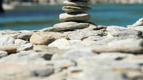 Stones-stacked-into-a-cairn---macro-pedestal-up-reveal