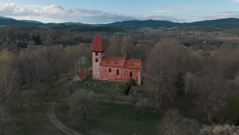 Flying-around-the-church-of-saint-Mikuláš-in-Boletice-in-Czechia,-Europe