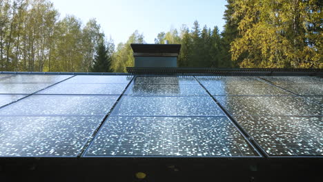 Glowing-solar-cells-collecting-sunlight-on-a-house-roof---Motion-Graphics-render