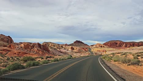 Driving-Along-Northshore-Road-in-Overton-Toward-Valley-of-Fire-with-POV,-Road-Ahead-with-Scenic-Desert-Landscape,-Nevada,-USA