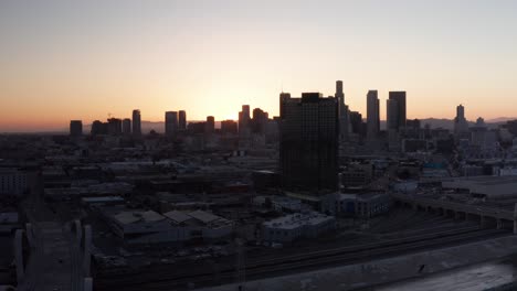 Low-aerial-dolly-shot-of-the-6th-Street-Bridge-and-Viaduct-at-sunset-in-downtown-Los-Angeles,-California