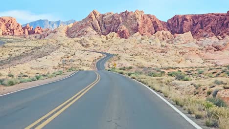 The-Valley-of-Fire-Drive-POV-with-Scenic-Surrounding-Landscape-of-Red-Rocks-and-Mountains,-Nevada,-USA
