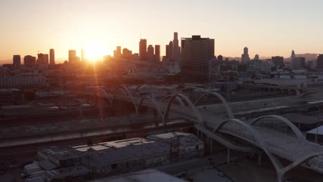 Descending-close-up-aerial-shot-of-the-6th-Street-Bridge-and-Viaduct-at-sunset-in-downtown-Los-Angeles,-California