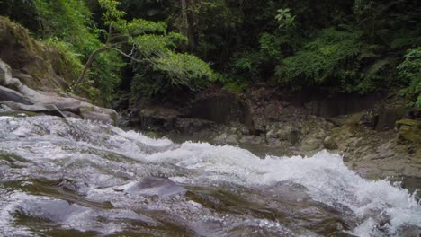 Water-gently-cascading-over-the-rocks-of-Goa-Rang-Reng-Waterfall-in-Bali,-captured-in-a-static-extreme-slow-motion-shot