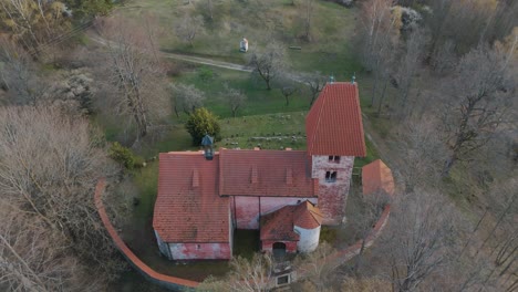 Flying-above-the-church-of-saint-Mikuláš-in-Boletice-in-Czechia,-Europe