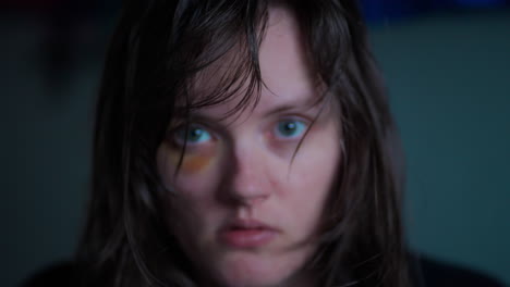 Close-up-of-a-young-terrified-woman-with-bruised-eye-looking-at-the-camera-in-slow-motion