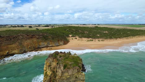 4k-drone-video-moving-forward-over-the-rocks-and-panning-down-to-reveal-more-of-a-white-sand-beach-on-the-Great-Ocean-Road