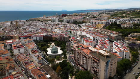 Downtown-of-Estepona-city-with-rooftops-and-apartment-buildings,-aerial-drone-view
