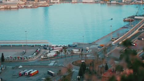 Birdseye-view-of-roundabout-near-harbour-on-a-sunny-day-truckers-driving