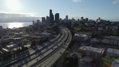 Drone-following-traffic-on-interstate-90-toward-downtown-Seattle,-in-sunny-USA