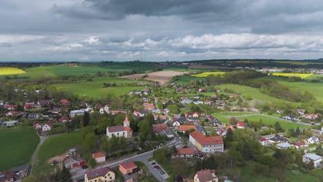 Flying-above-a-czech-village-Kostelec-u-Křížků-with-fields-in-the-background
