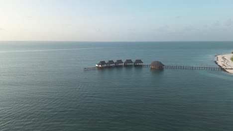 Aerial-view-towards-luxurious-thatched-roof-Kae-Funk-chalets-Indian-ocean-beach-resort-in-Zanzibar-Chwaka-bay