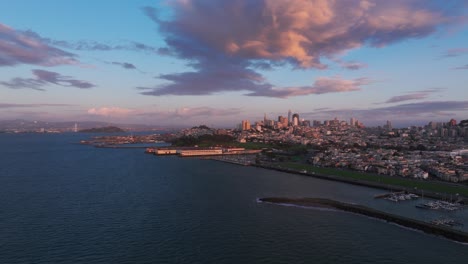 Drone-aerial-view-of-the-harbors-and-ferry-buildings-in-San-Francisco-at-sunset