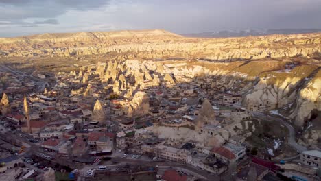 Aerial-Drone-View-of-Goreme,-Turkey:-Scenic-Town-Nestled-in-the-Heart-of-Cappadocia's-Unique-Rock-Formations---Fairy-Chimneys:-Downtown-of-Göreme,-Nevşehir-Türkiye