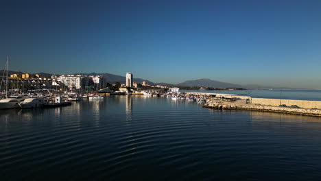 Mediterranean-seascape-and-city-of-Estepona,-aerial-drone-ascend-view