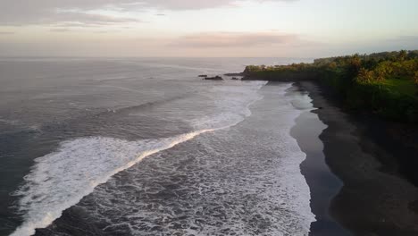 Balian-surfers-beach,-waves-in-motion-along-the-shoreline-during-sunrise