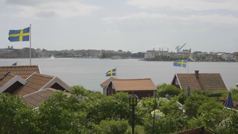 Swedish-Cottages-Displaying-National-Pride-with-Waving-Flags