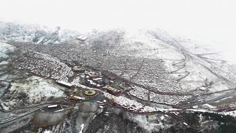 High-aerial-shot-of-the-Larung-Gar-Buddhist-Academy-and-community-in-winter,-Tibet,-China