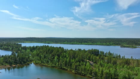 Lakes-and-wetlands-in-Vatsari-wilderness,-summer-in-Lapland---Aerial-rising-shot