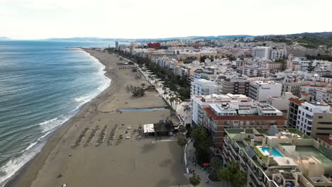 Coastal-resort-city-with-hotels-and-sandy-beach-in-Spain,-aerial-drone-view