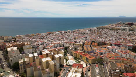 Coastal-city-of-Estepona-and-sea-horizon,-aerial-drone-view