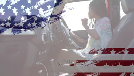 Animation-of-flag-of-usa-over-african-american-woman-in-car-on-beach