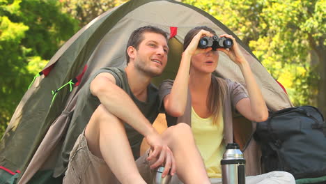 Attractive-couple-looking-through-binoculars-