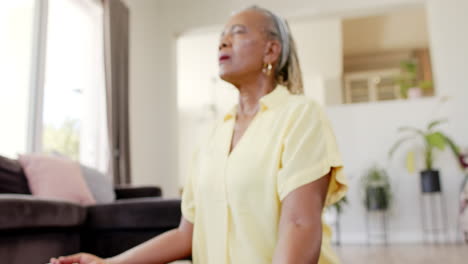 A-senior-African-American-woman-with-grey-hair-is-meditating-at-home