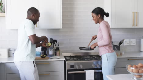 A-diverse-couple-cooks-breakfast-in-modern-kitchen