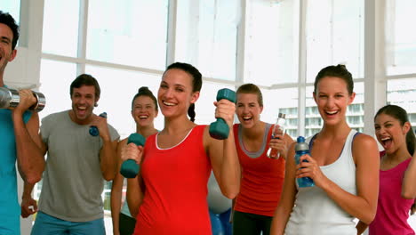 Fitness-class-smiling-at-camera-with-exercise-balls