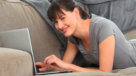 Brunette-enjoying-a-chat-on-a-laptop