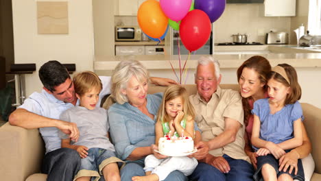 Extended-family-celebrating-little-girls-birthday-on-couch