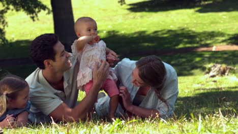 Young-family-relaxing-in-the-park-together