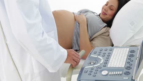 Brunette-pregnant-woman-having-a-sonogram-scan