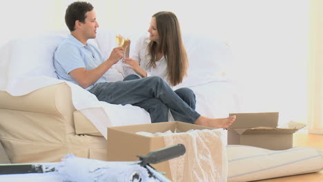 Couple-toasting-with-a-glass-of-white-wine-during-the-move