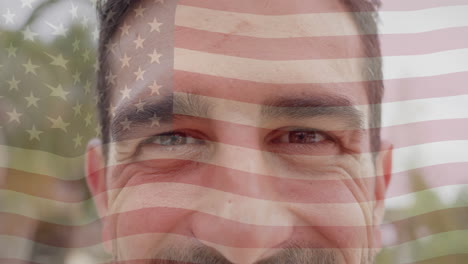 Animation-of-american-flag-over-portrait-close-up-of-happy-caucasian-man-smiling-in-sunny-garden