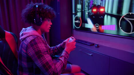 A-young-biracial-man-talks-on-his-gaming-headset-at-home,-copy-space