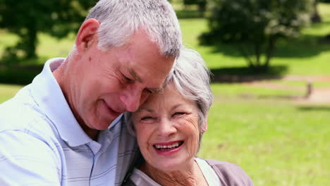 Senior-couple-relaxing-in-the-park-together