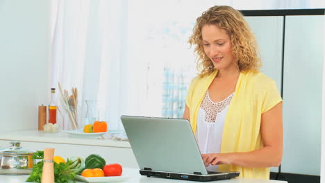 Curly-haired-woman-looking-at-a-recipe-