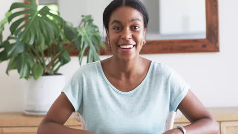 A-young-African-American-wife-smiles-warmly,-gesturing-during-video-call