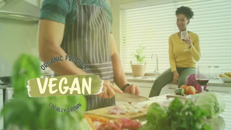 Animation-of-vegan-text-over-diverse-couple-preparing-healthy-meal-in-kitchen