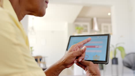 A-senior-African-American-woman-is-checking-home-energy-usage-on-tablet