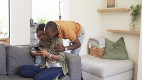 A-young-African-American-couple-enjoys-moment-on-couch